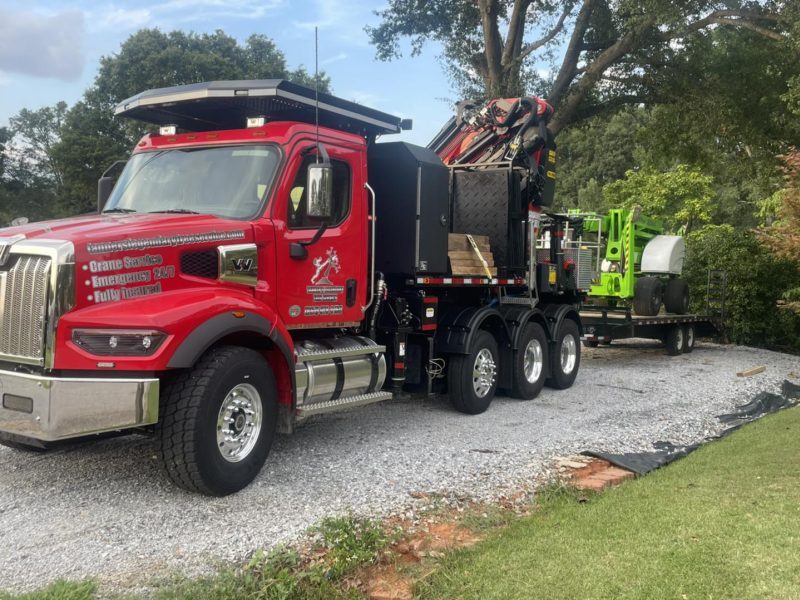 Tanner's Legendary Tree Service Western Star crane truck and equipment trailer ready for professional tree removal and crane services in Upstate SC